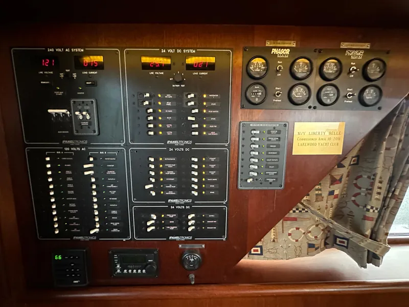 Slide: The Image of Electrical control panel on a 2010 Bertram 58 Convertible yacht, featuring various switches and gauges. - 41