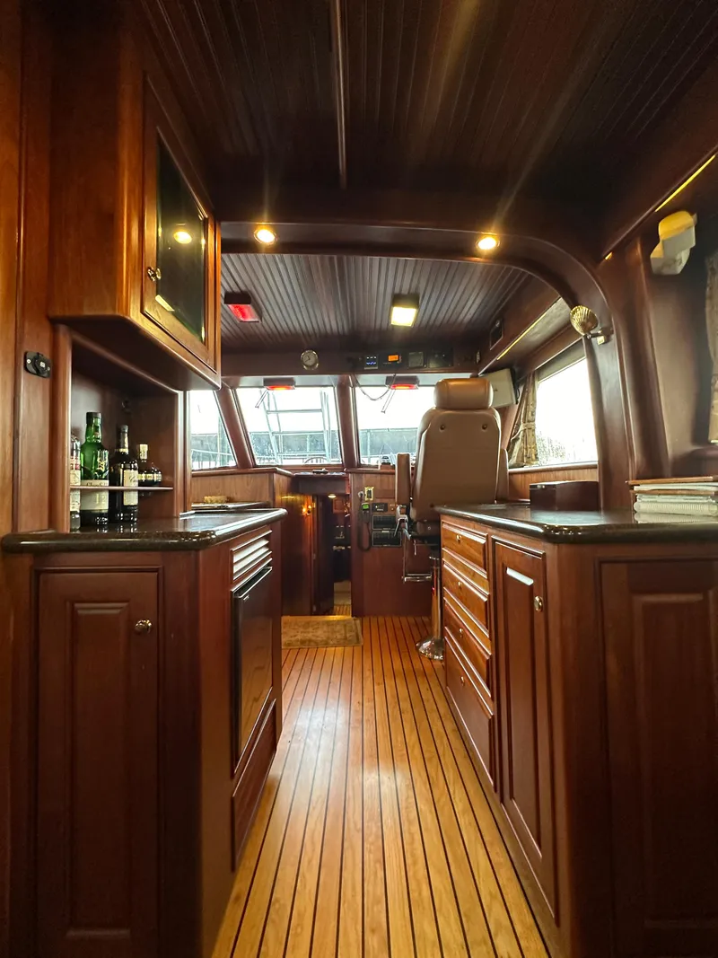 Slide: The Image of Luxurious interior of a 2010 Bertram 58 Convertible yacht with wooden cabinetry and flooring. - 45