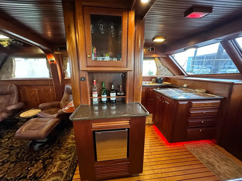 Slide: The Image of Luxurious interior of a 2010 Bertram 58 Convertible yacht with elegant wood finishes. - 47