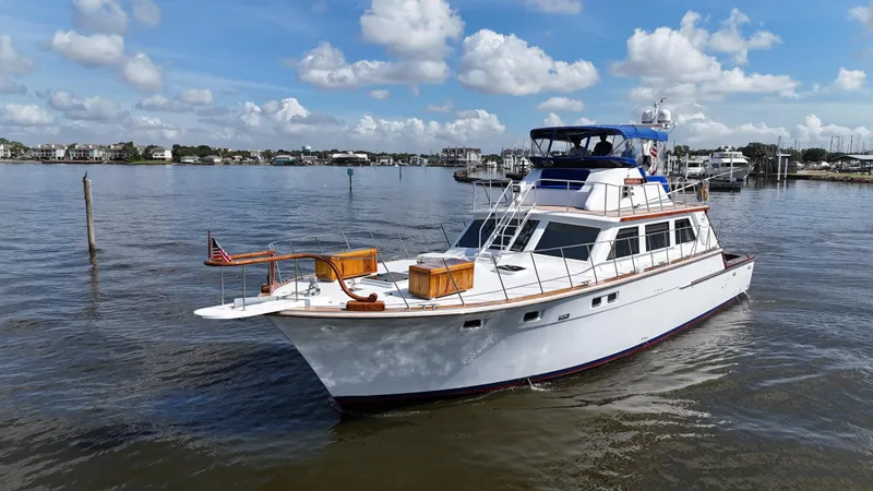 Slide: The Image of 1980 Bertram 58 Convertible Custom yacht on calm water under a blue sky. - 7