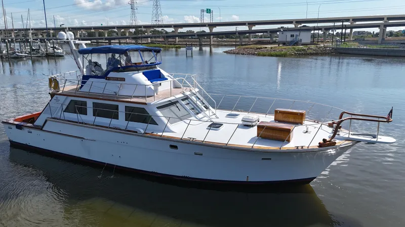Slide: The Image of 1980 Bertram 58 Convertible Custom yacht docked in a marina. - 8