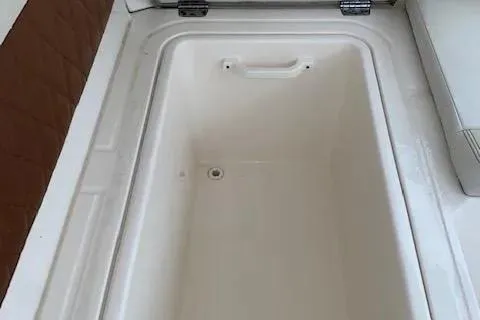 Slide: The Image of Storage compartment of 2021 Cobia 330 Dual Console boat. - 10