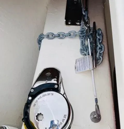 Slide: The Image of Anchor chain and windlass on a 2021 Cobia 330 Dual Console boat. - 13