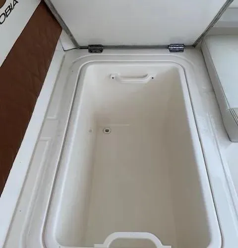 Slide: The Image of 2021 Cobia 330 Dual Console storage compartment. - 14