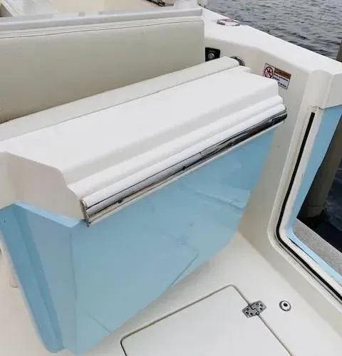 Slide: The Image of 2021 Cobia 330 Dual Console boat interior detail with blue and white seating. - 15