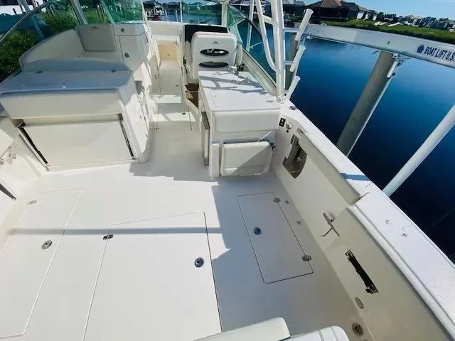 Slide: The Image of 2021 Cobia 330 Dual Console boat interior with spacious deck and seating. - 18