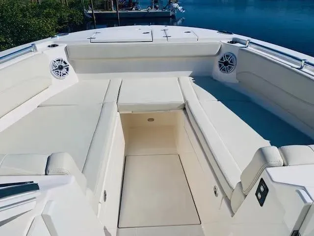 Slide: The Image of 2021 Cobia 330 Dual Console boat with spacious seating and marine speakers. - 25
