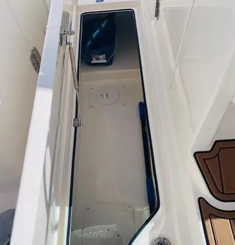 Slide: The Image of 2021 Cobia 330 Dual Console storage compartment interior. - 29