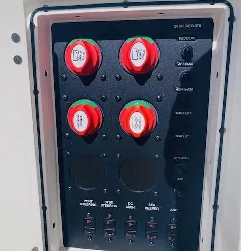 Slide: The Image of Control panel of a 2021 Cobia 330 Dual Console boat with labeled switches and dials. - 30