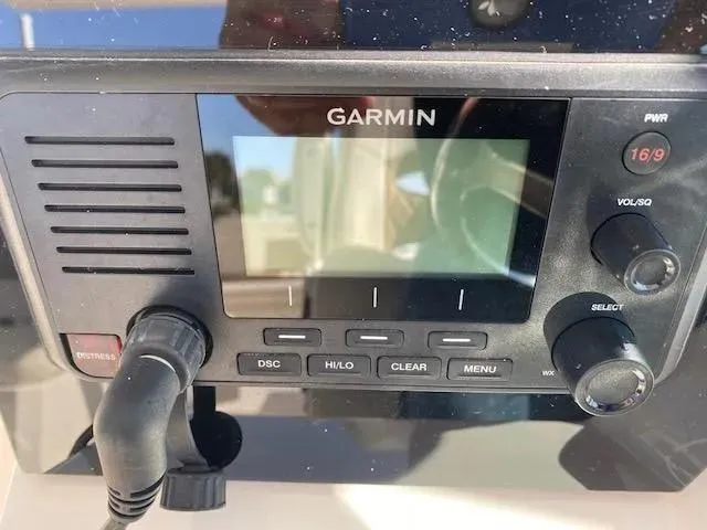 Slide: The Image of Garmin marine radio on 2021 Cobia 330 Dual Console boat. - 34