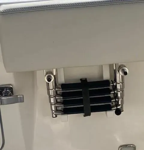 Slide: The Image of 2021 Cobia 330 Dual Console boat with a folded stainless steel swim ladder. - 35