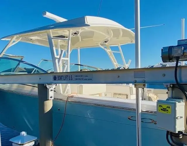 Slide: The Image of 2021 Cobia 330 Dual Console boat on a lift at a marina. - 42