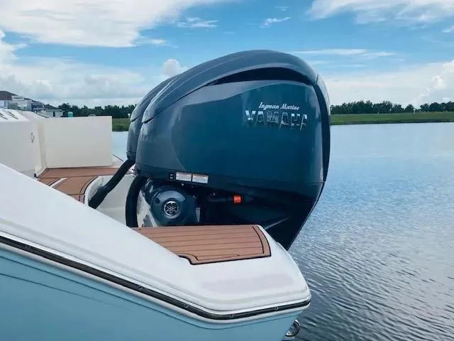 Slide: The Image of 2021 Cobia 330 Dual Console boat with Yamaha outboard motor on calm water. - 43