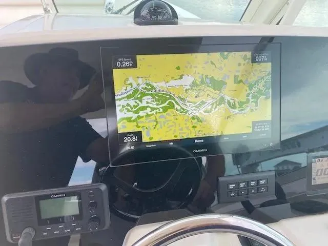 Slide: The Image of Garmin navigation system on 2021 Cobia 330 Dual Console boat dashboard. - 44