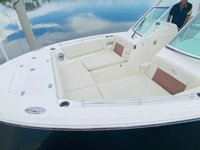 Slide: The Image of 2021 Cobia 330 Dual Console boat with spacious seating and sleek design. - 46