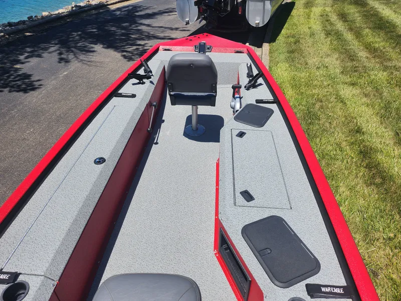 Slide: The Image of 2018 War Eagle 754VS Stick Steer boat with red trim and gray interior. - 10