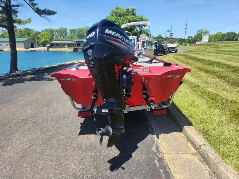 Slide: The Image of 2018 War Eagle 754VS Stick Steer boat with Mercury outboard motor by a lake. - 2