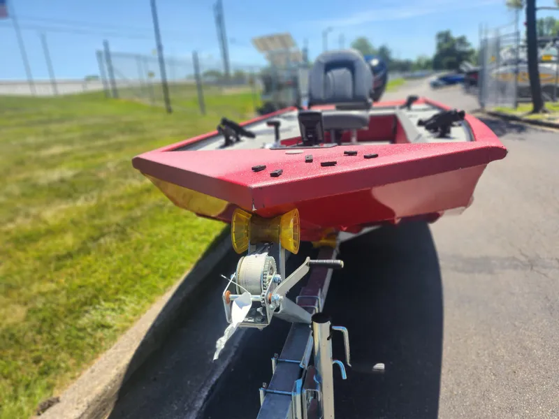 Slide: The Image of 2018 War Eagle 754VS Stick Steer boat on trailer, red exterior, parked outdoors. - 6