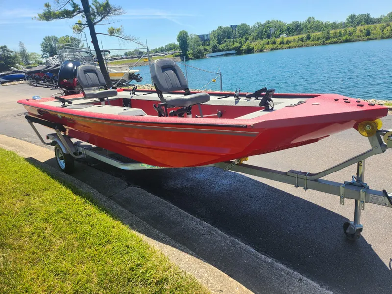 Slide: The Image of 2018 War Eagle 754VS Stick Steer boat on trailer by a lake. - 8