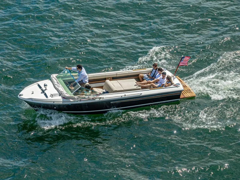 Slide: The Image of 1973 Century Coronado boat cruising with passengers on a sunny day. - 10