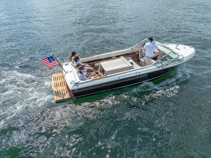 Slide: The Image of 1973 Century Coronado boat cruising with passengers on a sunny day. - 11