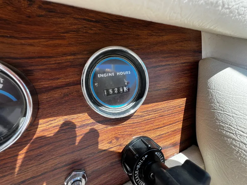 Slide: The Image of 1973 Century Coronado engine hours gauge showing 1524.5 hours on wooden dashboard. - 19