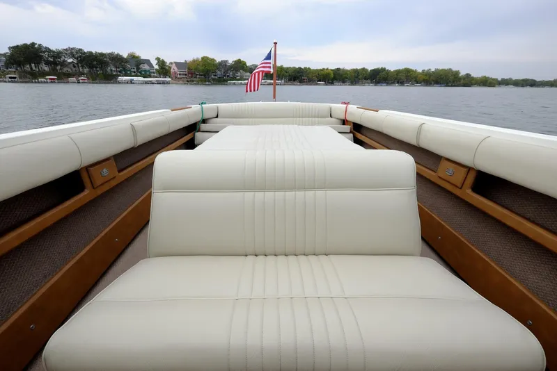Slide: The Image of 1973 Century Coronado boat interior with white leather seats on a lake. - 22