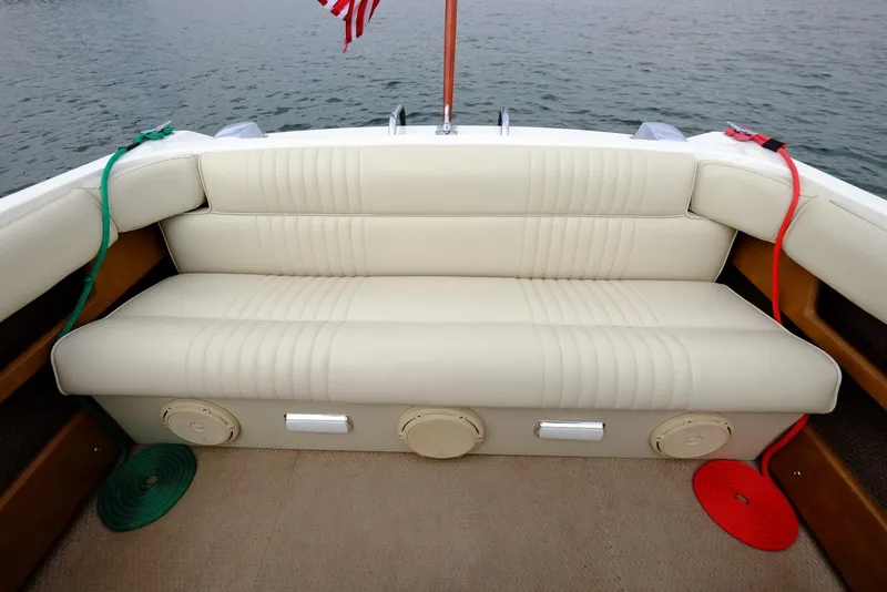 Slide: The Image of 1973 Century Coronado boat with beige leather seating and American flag. - 25
