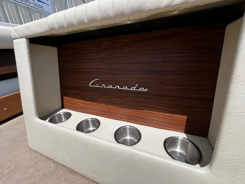 Slide: The Image of 1973 Century Coronado boat interior with wood paneling and cup holders. - 28