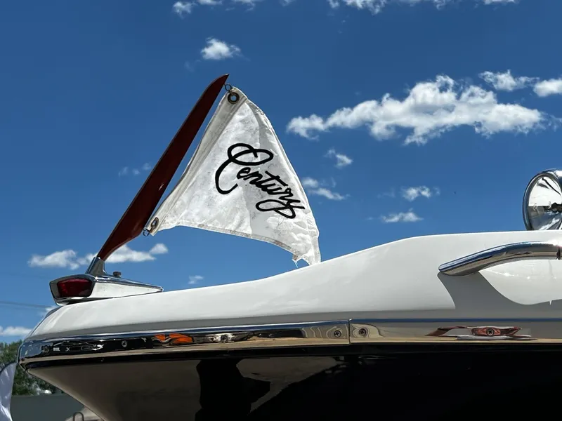 Slide: The Image of 1973 Century Coronado boat with flag against blue sky. - 3