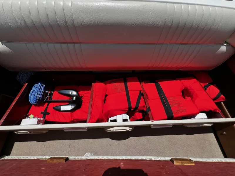 Slide: The Image of Storage compartment in a 1973 Century Coronado boat with life jackets and anchor. - 32