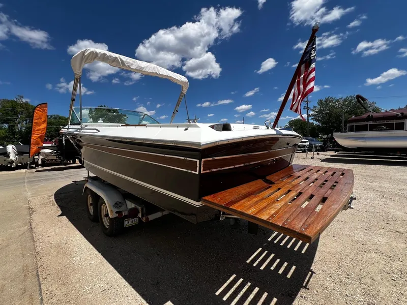 Slide: The Image of 1973 Century Coronado boat on trailer with American flag, sunny day. - 4