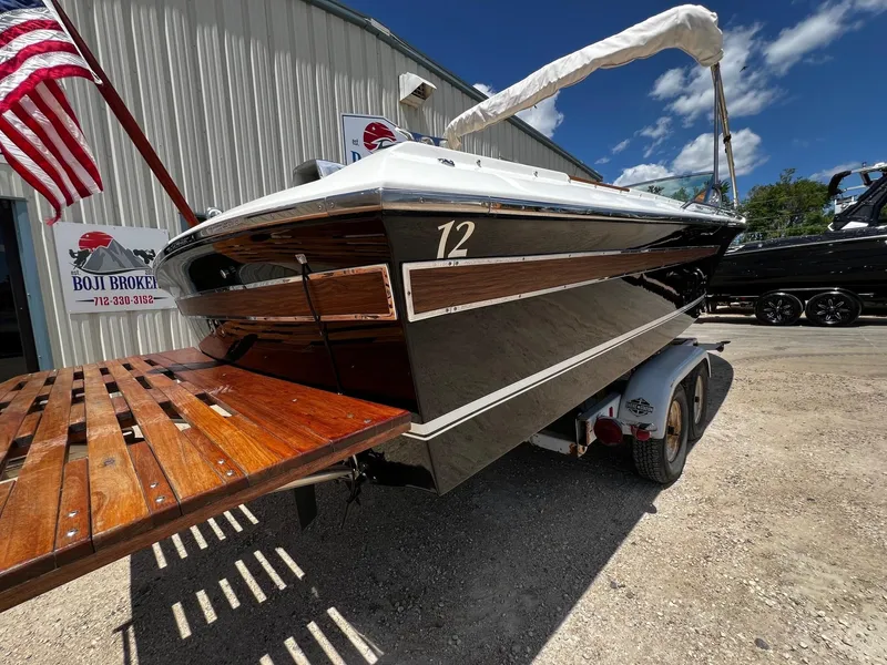Slide: The Image of 1973 Century Coronado boat on trailer with American flag and Boji Broker sign. - 6