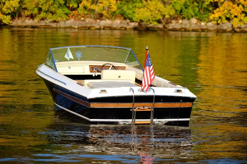 Slide: The Image of 1973 Century Coronado boat on a calm lake with autumn foliage. - 9