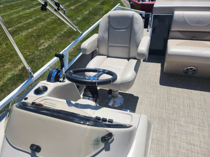 Slide: The Image of Captain's chair and helm of a 2019 JC 222 Spirit pontoon boat. - 12
