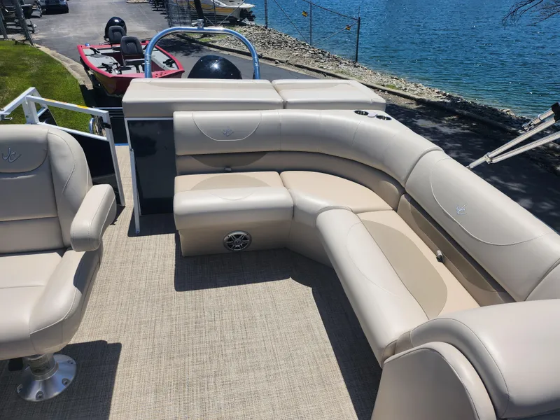 Slide: The Image of 2019 JC 222 Spirit pontoon boat with beige seating and lake view. - 13