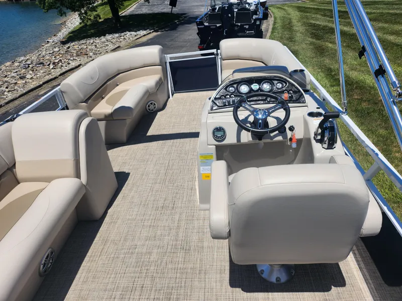 Slide: The Image of 2019 JC 222 Spirit pontoon boat interior with beige seating and control console. - 18