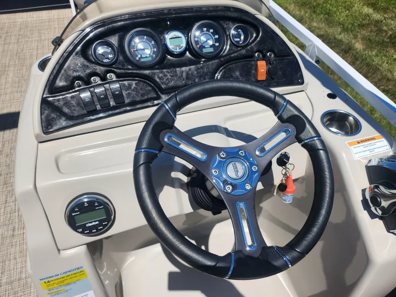 Slide: The Image of Steering console of a 2019 JC 222 Spirit boat with gauges and controls. - 19