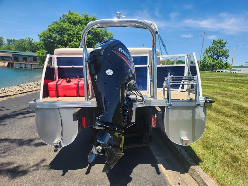 Slide: The Image of Rear view of a 2019 JC 222 Spirit pontoon boat with Mercury outboard motor. - 2