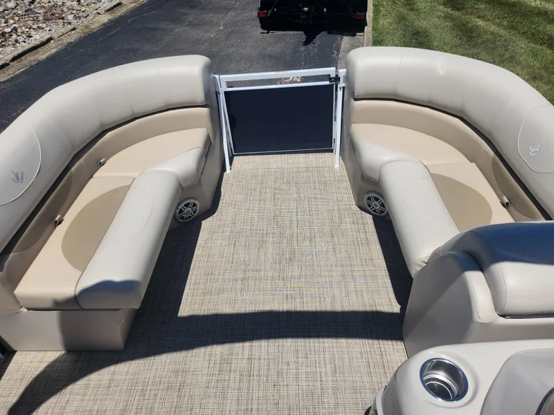 Slide: The Image of 2019 JC 222 Spirit boat interior with beige seating and carpeted floor. - 22