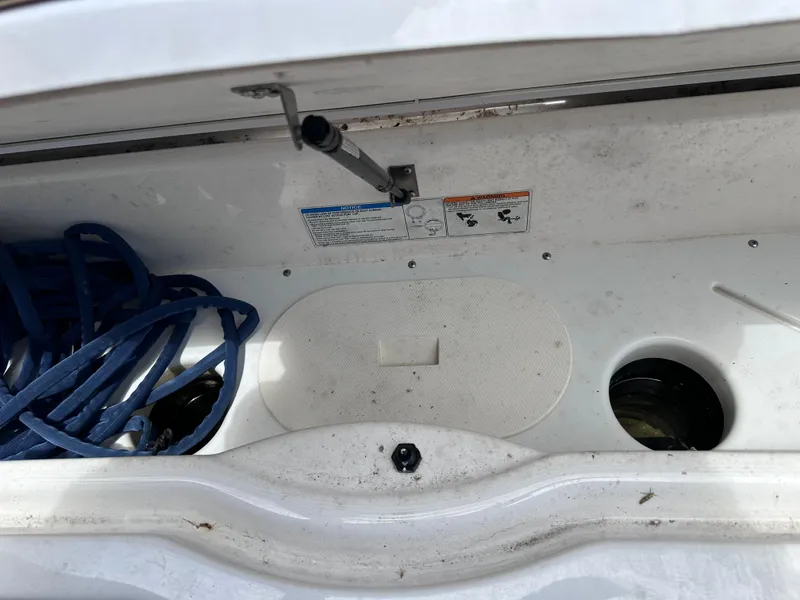Slide: The Image of Storage compartment of a 2021 Yamaha Boats 252 SD with blue rope. - 11