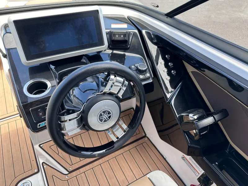 Slide: The Image of 2021 Yamaha Boats 252 SD dashboard with steering wheel and touchscreen display. - 12