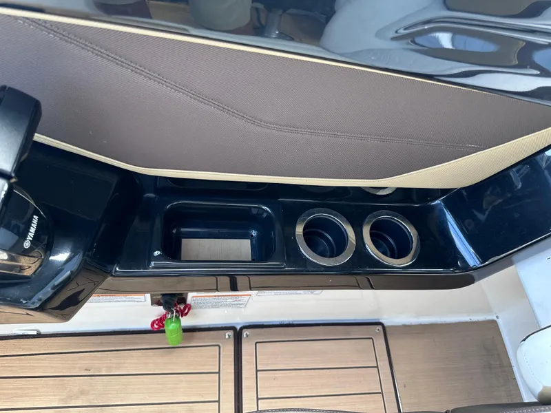 Slide: The Image of Yamaha Boats 2021 252 SD interior console with cup holders and storage compartments. - 16