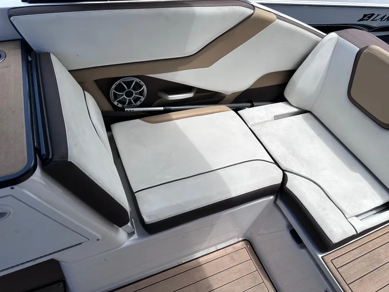 Slide: The Image of 2021 Yamaha Boats 252 SD interior seating with speaker and cushioned seats. - 23