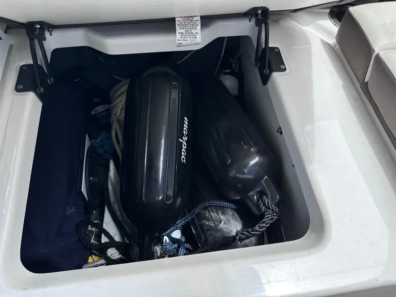 Slide: The Image of Storage compartment of a 2021 Yamaha Boats 252 SD with marine equipment. - 25