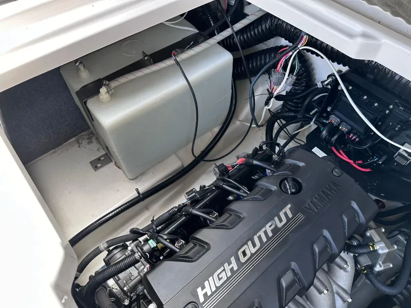 Slide: The Image of 2021 Yamaha Boats 252 SD engine compartment with high output engine and wiring. - 29