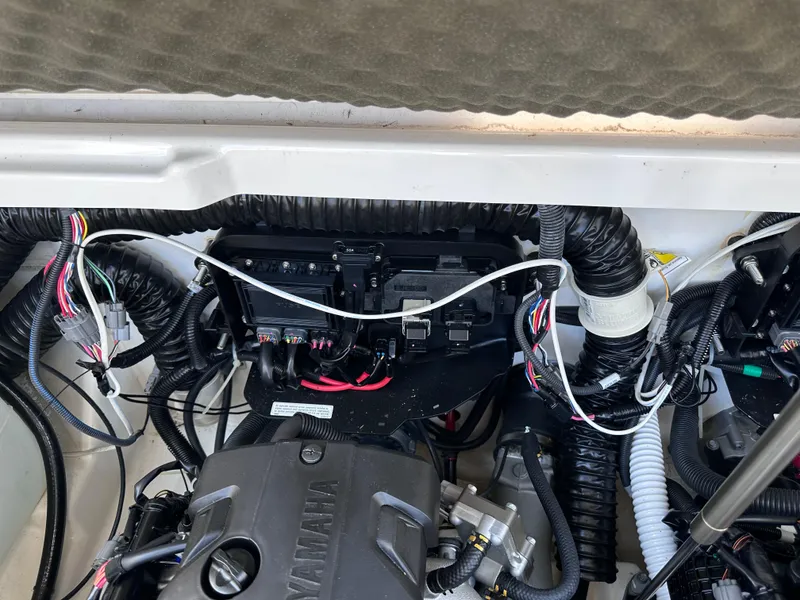 Slide: The Image of Engine compartment of a 2021 Yamaha Boats 252 SD with wiring and components. - 30