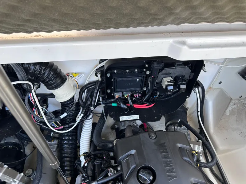 Slide: The Image of Engine compartment of a 2021 Yamaha Boats 252 SD, showcasing wiring and components. - 31