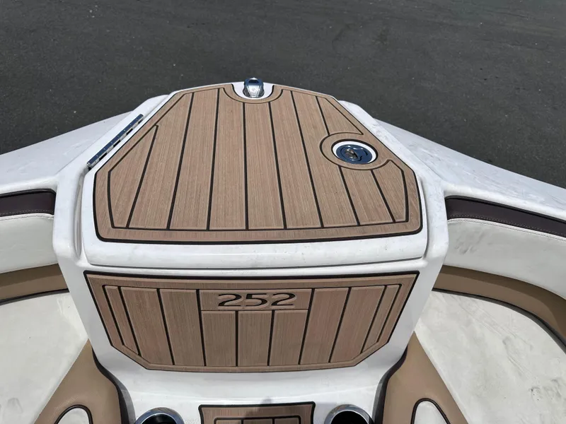 Slide: The Image of 2021 Yamaha Boats 252 SD bow with teak flooring and storage compartment. - 39