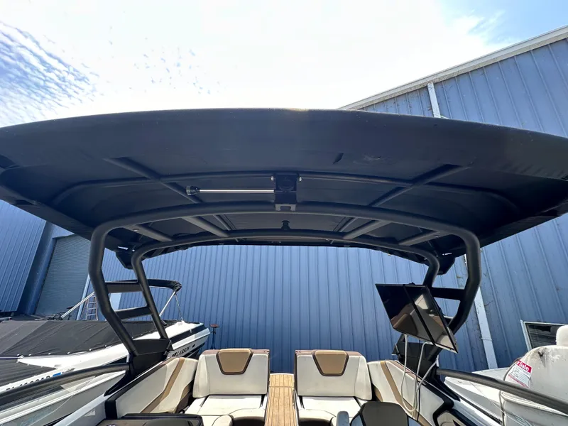 Slide: The Image of 2021 Yamaha Boats 252 SD interior with black canopy and seating. - 41